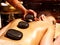 Woman having Ayurvedic stone massage.