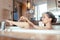 Woman having bath in hotel bathtub grabbing her shaver