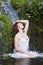 Woman having a bath in a waterfall