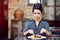 Woman having breakfast at the indoor cafe