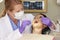 Woman Having Check Up At Dentists Surgery