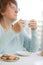 Woman having coffee with cookies