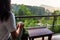 Woman having a cup of tea on the balcony