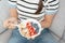 Woman having delicious healthy breakfast at home on morning. Health care female eats yogurt with granola and berry fruit. Healthy