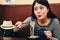 Woman having dinner with tasty japanese cuisine