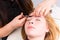 Woman Having Eyebrows Trimmed by Esthetician