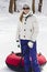 Woman having fun going snow tubing on a winter day