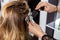 Woman Having Hair Dyed By Beautician At Parlor