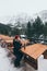 Woman having a hot drink from thermo cup overlooking snowcapped High Tatra mountains peaks