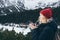 Woman having a hot drink from thermo cup overlooking snowcapped High Tatra mountains peaks