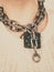 Woman having metal chain around neck