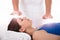 Woman Having Reiki Healing Treatment