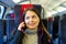 Woman having telephone conversation while traveling by train