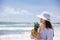 Woman having a tropical drink at a paradisiac tropical beach in a beautiful sunny day