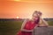 woman on hay stack on sunset.