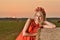 woman on hay stack on sunset.