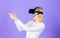 Woman head mounted display violet background. Virtual reality shooting gallery. Girl use modern technology vr headset