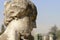 Woman head of smoothened stone at Monumental Cemetery, Milan