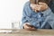 A woman with a headache consults a doctor on a smartphone. Remote diagnosis and treatment, telemedicine