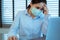 Woman headache with face mask protection while working, Coronavirus, air pollution, allergic sick woman with medical mask