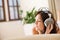 Woman with headphones listen to music in lounge