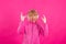 Woman with headphones and rebel gesture isolated on color background