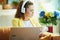 Woman with headphones subscribing to online education website