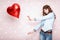 Woman with heart shaped air balloons