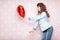 Woman with heart shaped air balloons