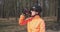 Woman in helmet and sunglasses drinks water from bottle. Portrait of female cyclist drinking isotonic drink. Close up of girl with