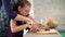 Woman help child to cut apple slice. Mother and daugther cooking together