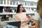 Woman helping customer to choose perfume in shop