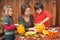 Woman helping kids to carve jack-o-lanterns