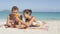 Woman helping man with sunscreen at beach