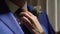 Woman helping to put on and fixing necktie. Groom in suit with tie in wedding day