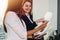 Woman and her assistant holding documents discussing business plan and strategy at workplace