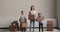 Woman her children holding parcel boxes smiling looking at camera