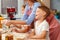 Woman with her children kneading dough in kitchen