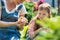 Woman with her daughter holding a baby chick in her hands very carefully