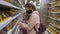 A woman with her daughter in protective medical masks in the supermarket during a pandemic coronavirus.