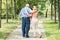 Woman With Her Disabled Father Standing In Park