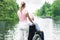 Woman With Her Disabled Father On Wheelchair Looking At Lake