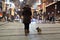 Woman and her dog walking in the cold winter night through the central station in Vienna