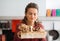 Woman with her eyes closed smelling basket of fresh mushrooms