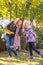 woman and her little daughter shows autumn leaves