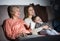 Woman with her mother and son are watching film in time evening rest