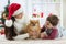 Woman and her son celebrating christmas with furry friend. Mother and kid with terrier dog. Pretty child boy with puppy