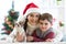 Woman and her son celebrating christmas with furry friend. Mother and kid with terrier dog. Pretty child boy with puppy at x-mas t