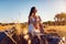 Woman in her vacation sitting on a stone wall in rural Alentejo, Portugal