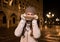 Woman hiding behind the collar while spending fun time in Venice